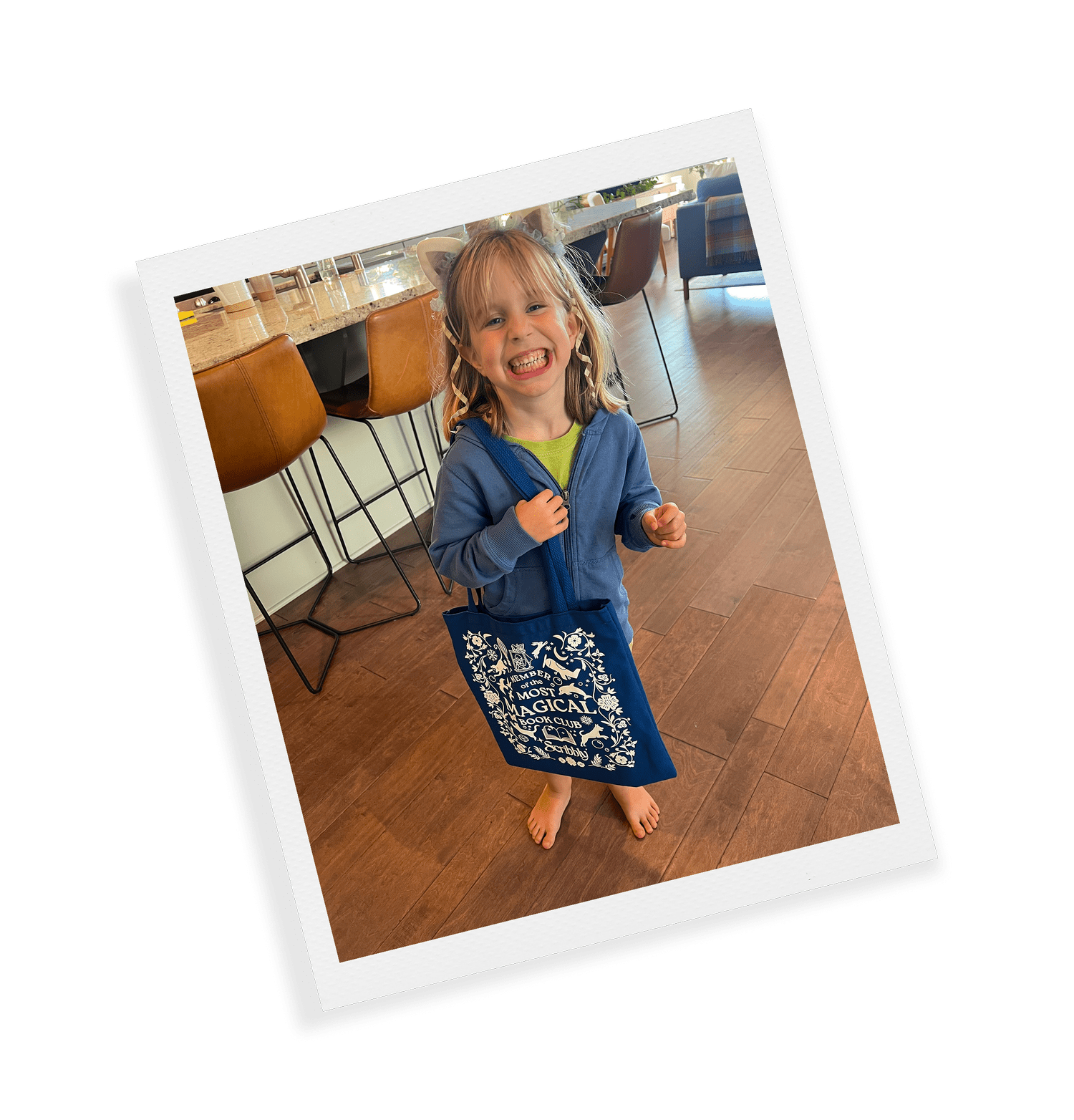 A grinning kid carrying the official member tote
